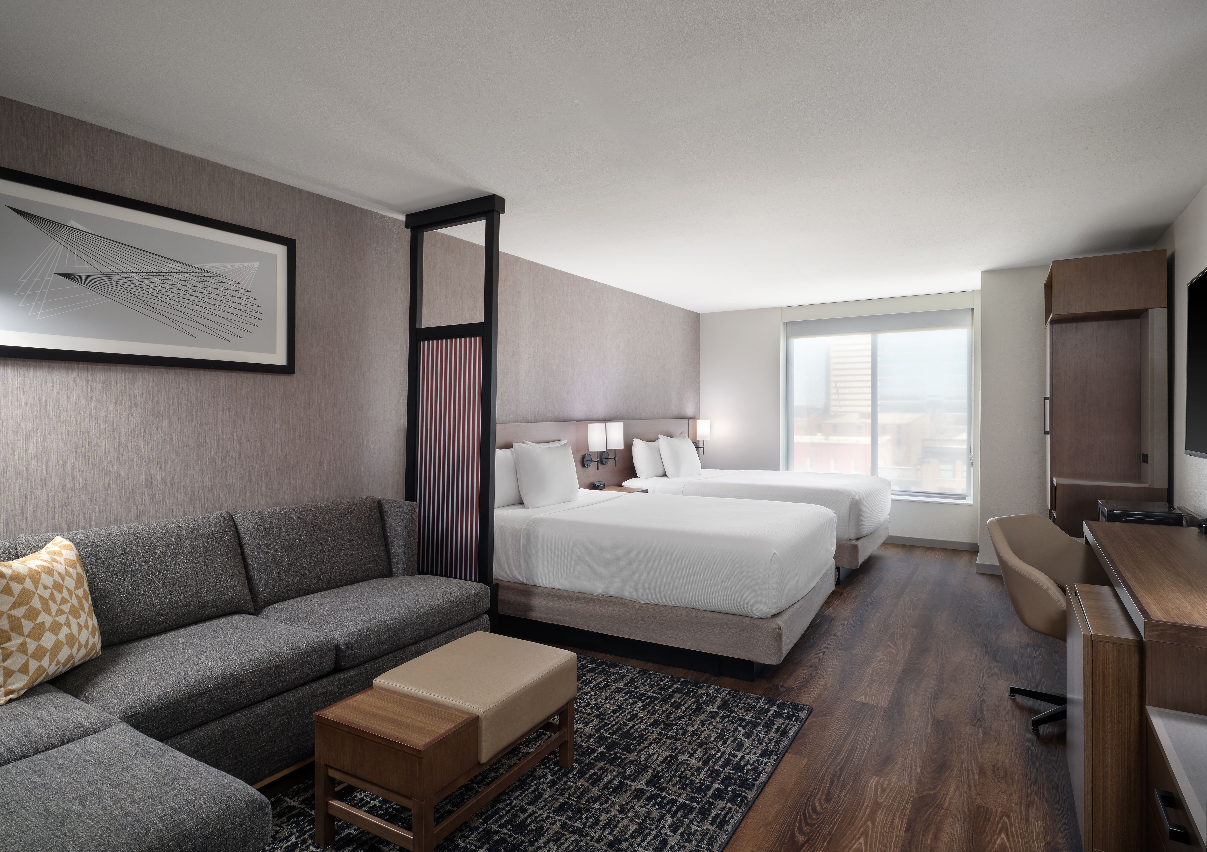 Hyatt Place Omaha Downtown high-floor room with two queen beds, a seating area, and modern furnishings.